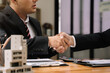 © NINENII - Close up two men shake hands at office negotiations. Making deal sign, conclude contract, formal greeting, strike bargain. Successful negotiations, insurance home loan concept.