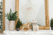 Rocking Horse, Fir Branches In A Vase, A Christmas Tree In A Pot, Souvenir Houses As A Room Decoration For Christmas And New Year