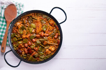 Paella with green beans and sausages. Typical Spanish paella tapa recipe with meat.