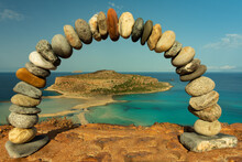 Dreamlike Scenery Of The Greek Islands - Balos Bay With Finest Beaches And Turquoise Sea. Crete Island. View Through A Stone Arch To The Beautiful Bay. Balance And Stability Project.