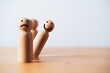 smile face on wooden figure out of line from sad face with copy space for positive mindset selection concept.
