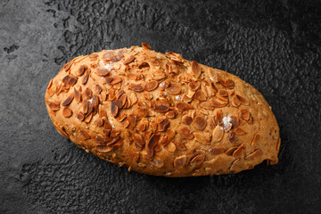 Wall Mural - Fresh Homemade bloomer bread with almond flakes on rustic dark background