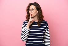 Young Caucasian Woman Isolated On Pink Background Showing A Sign Of Silence Gesture Putting Finger In Mouth
