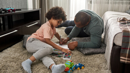 Wall Mural - Dad and son draw with felt tip pens in sketchbook