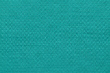 An Extreme Close-up Of The Cover Of A Vibrant Aqua Coloured Hardback Book Showing A Pattern Of Dimples And Nodules All In Rows, Flat, Vertical And Parallel To Camera, Captured In A Studio 