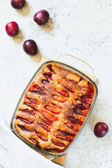 Wall Mural - rustic plum cake. Copy space. Top view, flat lay. Simple baking concept.