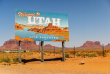 Fototapeta  - UTAH, UNITED STATES - SEPTEMBER 4, 2022: Utah sign across the road to Monument Valley a region of the Colorado Plateau characterized by a cluster of vast sandstone buttes.