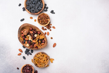 Wall Mural - Wooden bowls with raisins, nuts and dried cranberries as ingredient for tasty dessert