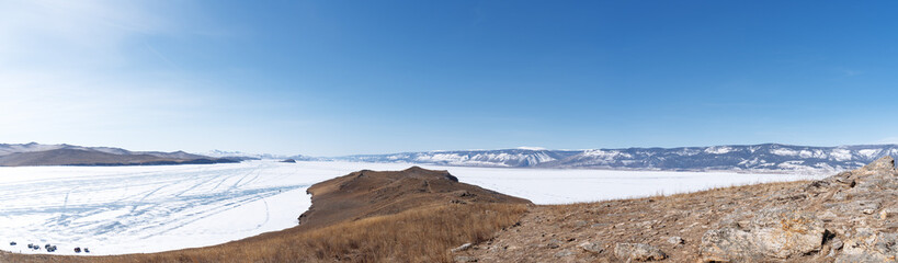 Wall Mural - Winter landscape panorama with mountains and Lake Baikal in Siberia on sunny day. Natural background.