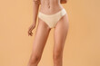 © Pixel-Shot - Slim young woman in underwear on beige background