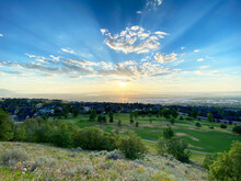 Sunset Over Rural Spring Landscape With Cityscape In The Distance, Utah, USA