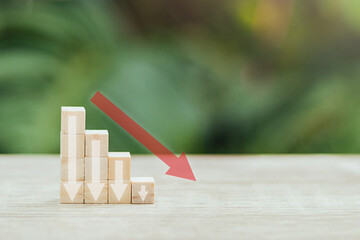 Wooden blocks with down arrow on desk with copy space. financial recession crisis, risk management concept. money rate price down.