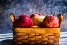Close-up Of A Basket Of Red Apples On A Table
