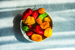 © RooM The Agency - Overhead view of a bowl of assorted red, yellow and green chilli peppers