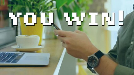 Sticker - Animation of you win text over caucasian man using smartphone