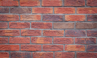 Poster - Old red brick wall grunge texture. Old seamless cracked bricks wall with a weathered surface with with vignetted corners. Brick wall background, copy space for design and text.