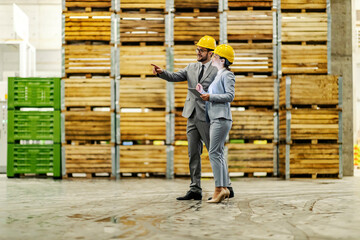 Wall Mural - Businesspeople in storage talking and discussing while dispatching around storage.