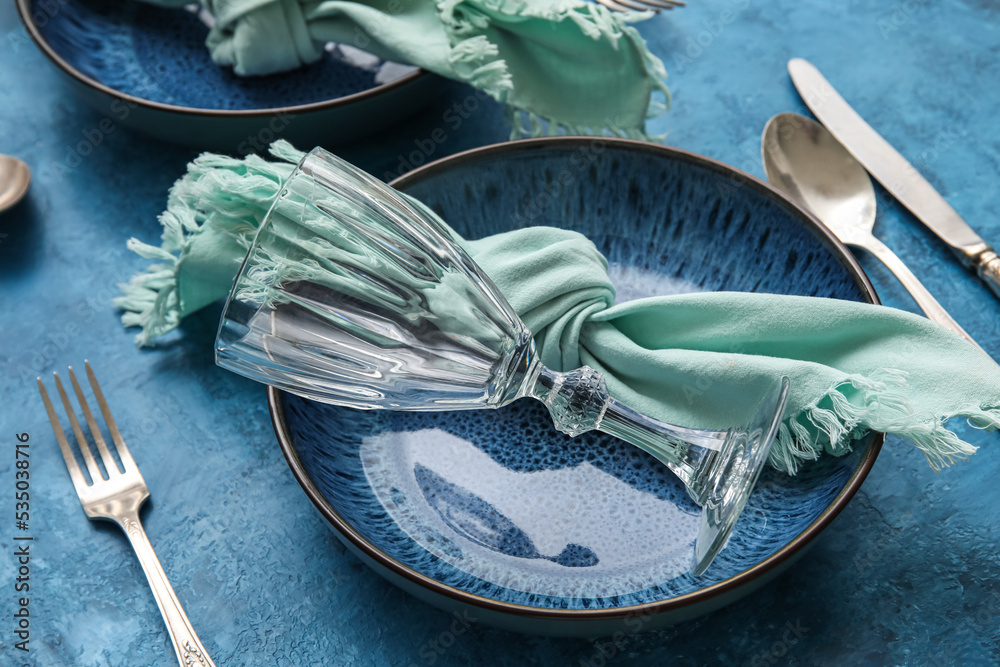 Closeup view of dinnerware on blue table