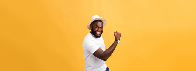 Wall Mural - Handsome young Afro-American man employee feeling excited, gesturing actively, keeping fists clenched, exclaiming joyfully with mouth wide opened, happy with good luck or promotion at work