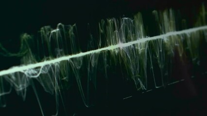 Thin light green waveform of sound vibration on black background macro view. Controlling quality of audio record. Monitoring process