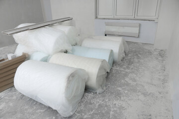 Wall Mural - Polyethylene foam rolls in room prepared for renovation
