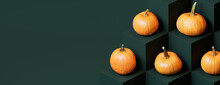 Pumpkins On Dark Green Colored Cubes. Autumn Themed Banner With Copy-space.
