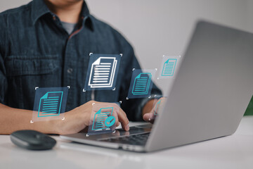 Aufkleber - Concept of a businessman using a laptop computer with a document management icon as part of a data system for business on the internet.