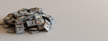 Bundled Currency Stacked Up On A White Surface With Copy-space. Prosperity Concept With One Hundred Dollar Bills.