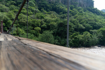 barranca huentitan, guadalajara, old wooden floor, wooden beams and crossbeams, mountains and tensioned cables, vegetation in the background