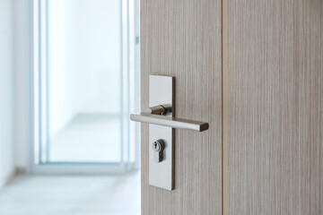 Closeup doorknob of wooden door between open or close the door