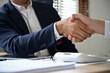 © bongkarn - Professional Asian businessman shaking hand with his business partner after the meeting