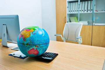 Wall Mural - Office desk with computer and globe