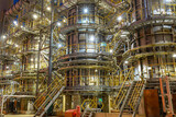 Fototapeta Krajobraz - overview of metal pipes of an oil refinery outdoors
