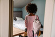 © Drobot Dean - Black curly girl standing with her backpack in bedroom