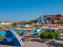 Beautiful View Of A Water Park With Colorful Slides And Swimming Pool On A Sunny Day.