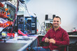 © Photocreo Bednarek - Electronics service shop owner at work repairing computer