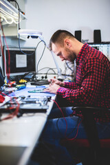 IT engineer technician repairing computer in electronics service shop