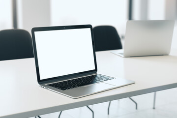 Poster - Close up of empty white laptop on white desktop, mock up place on screen, blurry office interior background. 3D Rendering.