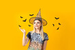 © Atlas - Concept of Halloween, young woman on yellow background
