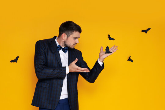 Concept of Halloween, young man on yellow background