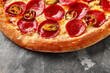 © nazarovsergey - Pizza with melted mozzarella, tomato sauce, pepperoni and jalapeno on gray stone