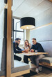© Jacob Lund - Group of businesspeople working in a co-working space