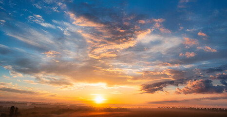 the dawn sky over the village. a wonderful morning landscape