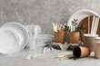 © New Africa - Plastic and eco disposable tableware with green twigs on marble table