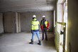 © Zelma - The architect of the building project and the construction manager walk around the interior of the new building