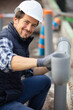 portrait of plumber with pipes on construction site