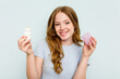 © Asier - Young caucasian woman holding deodorant isolated on blue background