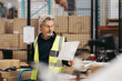 © Jacob Lund - Senior warehouse worker reading a packing list in a fulfillment center