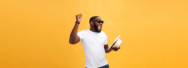 Young black man top dancing isolated on a yellow background.