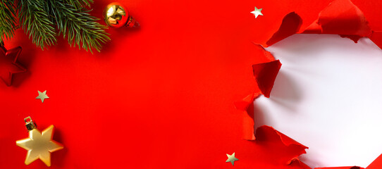 Wall Mural - christmas banner. christmas tree branch decorated golden color balls and stars on red background. wi
